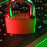 red padlock on black computer keyboard